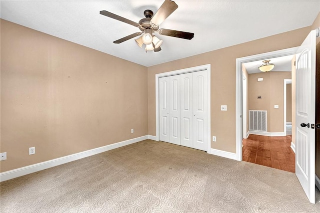 21 Sidlaw Hills Dr, Bella Vista, AR 72715 - unfurnished bedroom with carpet flooring, a closet, baseboards, and ceiling fan