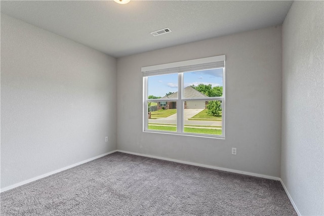 unfurnished room with carpet and baseboards