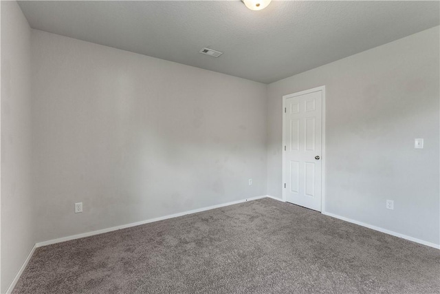 carpeted spare room featuring baseboards