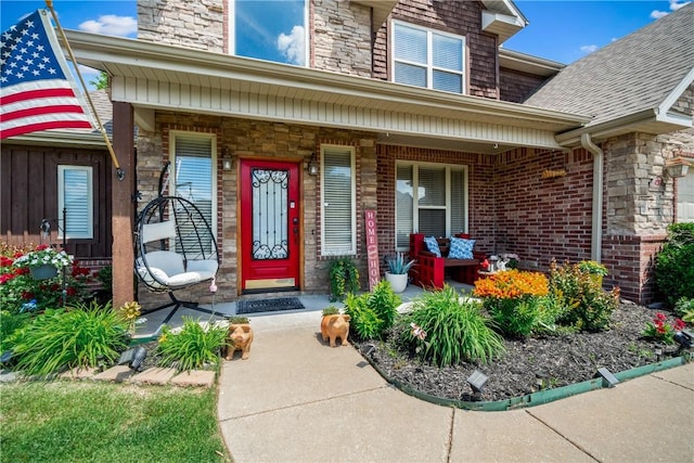 property entrance featuring a porch and stone siding