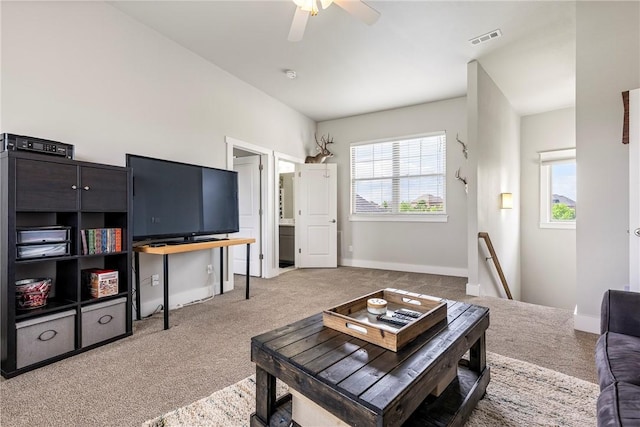 living area with carpet, ceiling fan, and baseboards