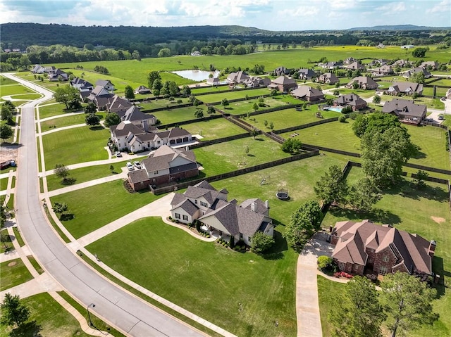 aerial view of property's location featuring nearby suburban area and a large body of water