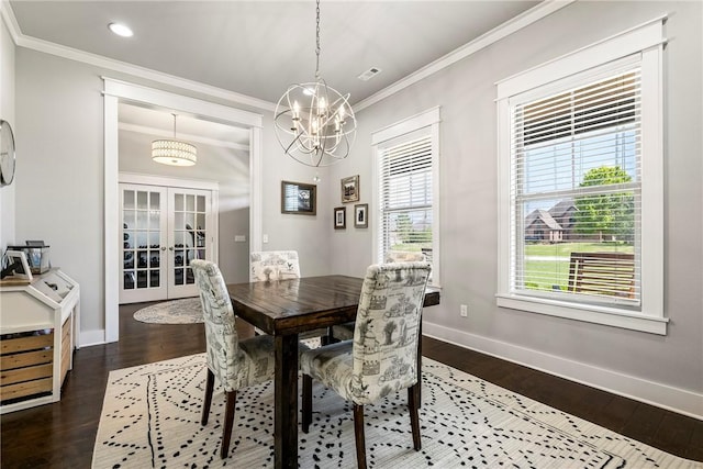 dining room featuring french doors, ornamental molding, dark wood finished floors, baseboards, and a chandelier