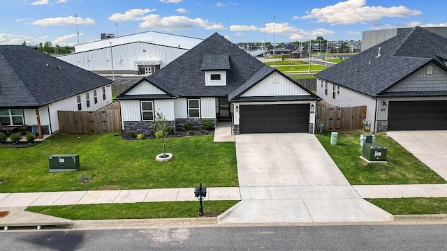 modern inspired farmhouse featuring stone siding, a shingled roof, an attached garage, a gate, and concrete driveway