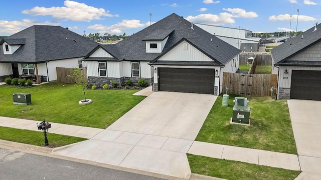 view of front of home featuring stone siding, board and batten siding, a shingled roof, and concrete driveway