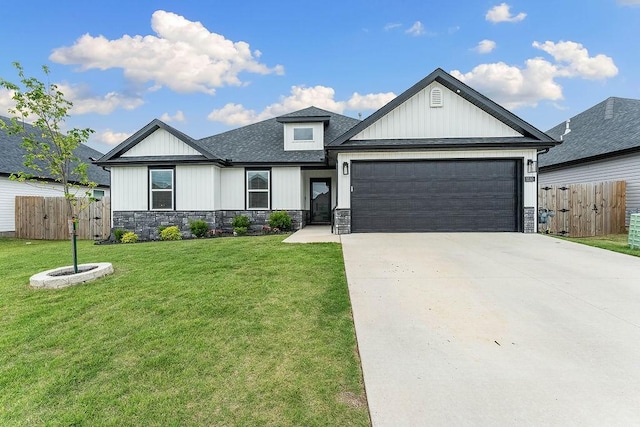 view of front of home with an attached garage, concrete driveway, stone siding, and roof with shingles