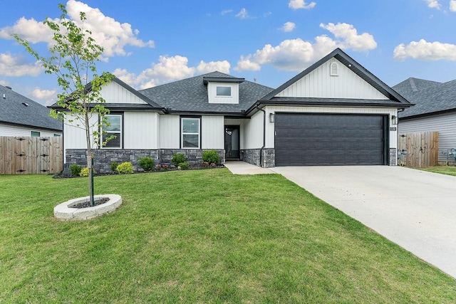 view of front of house with an attached garage, driveway, stone siding, roof with shingles, and board and batten siding