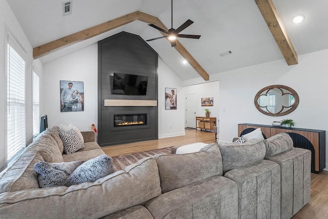 living room featuring a ceiling fan, light wood-style flooring, a fireplace, baseboards, and recessed lighting