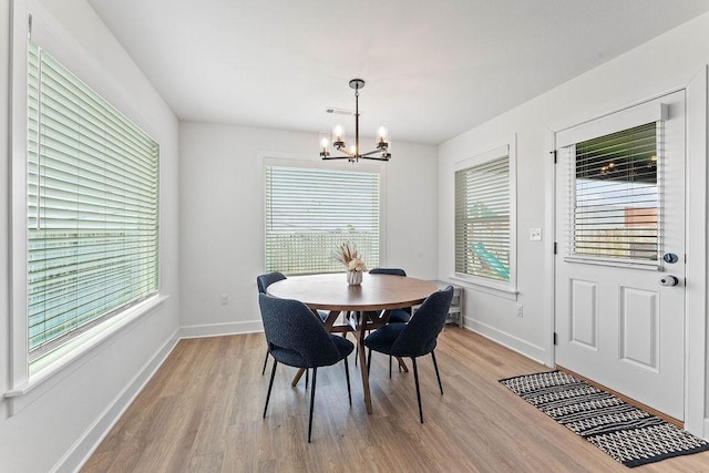 dining room featuring a chandelier, light wood-style floors, and plenty of natural light
