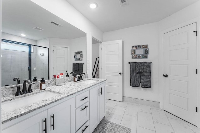 bathroom featuring a shower stall, marble finish floors, double vanity, and recessed lighting