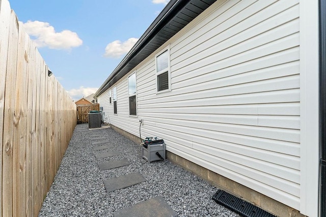 view of property exterior with a fenced backyard and cooling unit