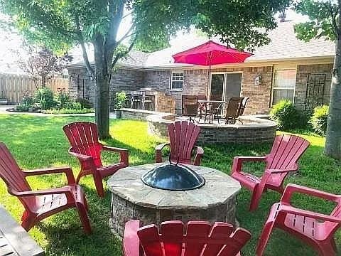 3801 SW Moline Ave, Bentonville, AR 72712 - view of patio with an outdoor fire pit