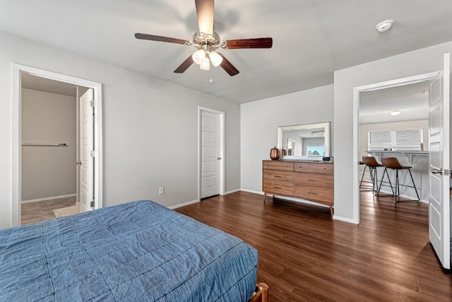 bedroom with wood finished floors, baseboards, and a ceiling fan