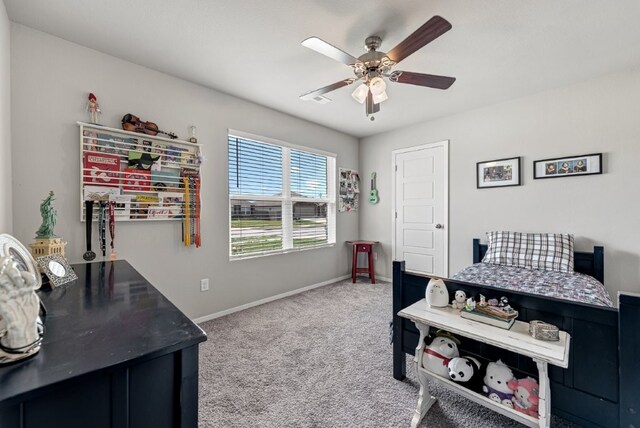 carpeted bedroom featuring baseboards and a ceiling fan