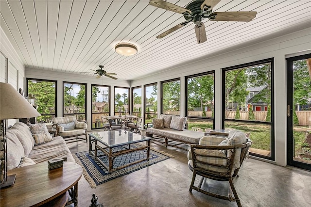 sunroom featuring ceiling fan, an outdoor hangout area, and outdoor dining area