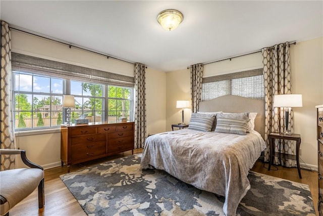 bedroom featuring wood finished floors and baseboards