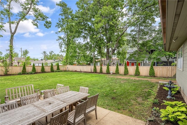 view of yard with outdoor dining area and a patio area
