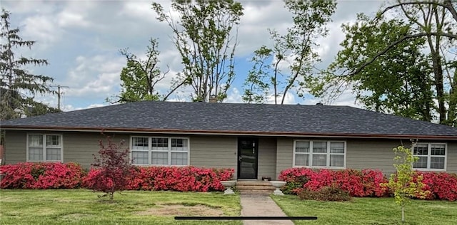 ranch-style home featuring a front yard