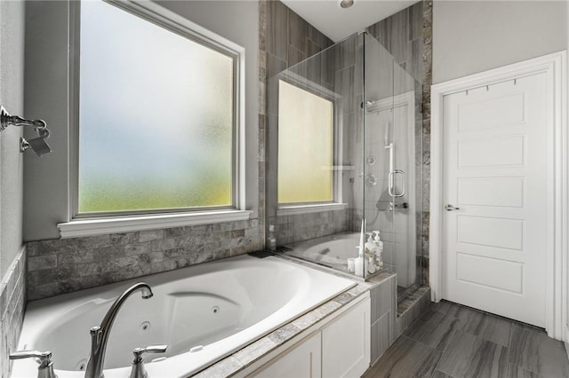 full bathroom with a stall shower and a jetted tub