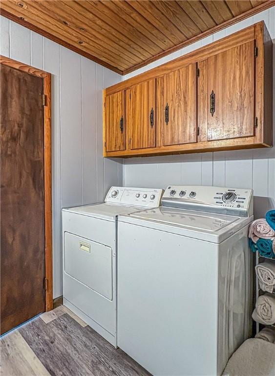 239 Mc 7043, Flippin, AR 72634 - washroom featuring cabinet space, wooden ceiling, washing machine and clothes dryer, and wood finished floors