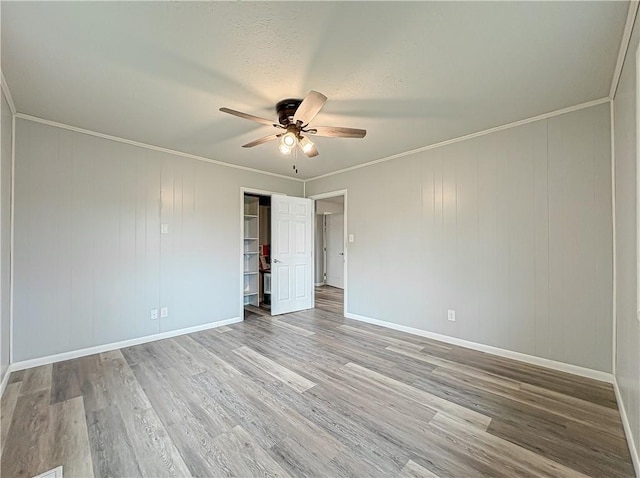 239 Mc 7043, Flippin, AR 72634 - unfurnished bedroom with wood finished floors, baseboards, ornamental molding, ceiling fan, and a closet