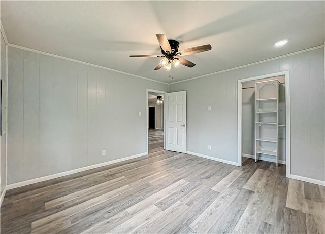 239 Mc 7043, Flippin, AR 72634 - unfurnished bedroom featuring wood finished floors, crown molding, ceiling fan, baseboards, and a closet