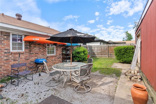 1207 SE E St, Bentonville, AR 72712 - view of patio / terrace featuring a fenced backyard and outdoor dining space