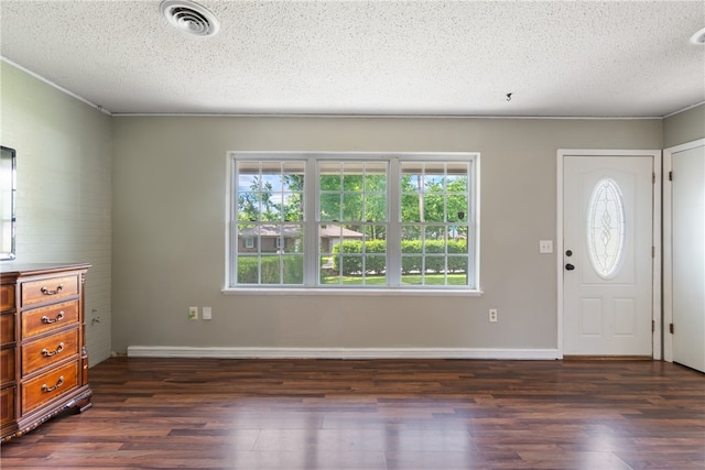 1207 SE E St, Bentonville, AR 72712 - entryway with dark wood finished floors, a textured ceiling, and baseboards