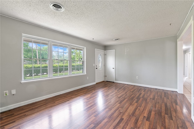 1207 SE E St, Bentonville, AR 72712 - unfurnished room featuring wood finished floors, a textured ceiling, and baseboards