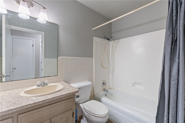 1207 SE E St, Bentonville, AR 72712 - bathroom featuring shower / bath combination with curtain, vanity, toilet, tile walls, and wainscoting