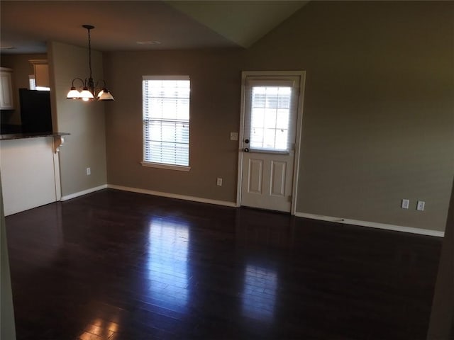3804 Gibson Ave, Bentonville, AR 72712 - interior space with dark wood-style floors, baseboards, a chandelier, and vaulted ceiling