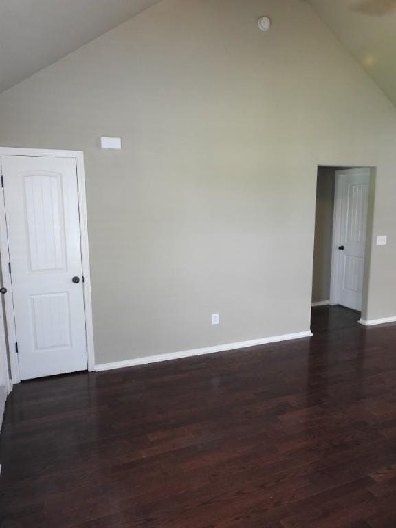 3804 Gibson Ave, Bentonville, AR 72712 - empty room with high vaulted ceiling, baseboards, and dark wood-style floors
