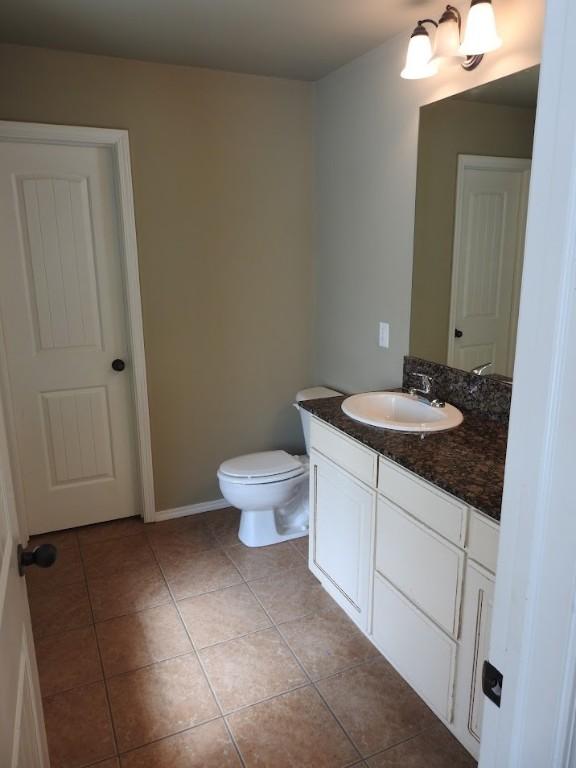 3804 Gibson Ave, Bentonville, AR 72712 - bathroom featuring tile patterned floors, vanity, toilet, and baseboards