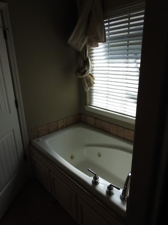 3804 Gibson Ave, Bentonville, AR 72712 - bathroom with a jetted tub and tile patterned floors