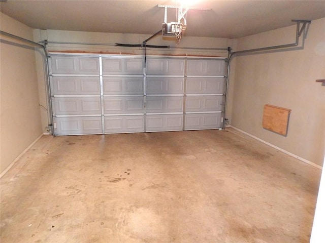 3804 Gibson Ave, Bentonville, AR 72712 - garage featuring a garage door opener and baseboards