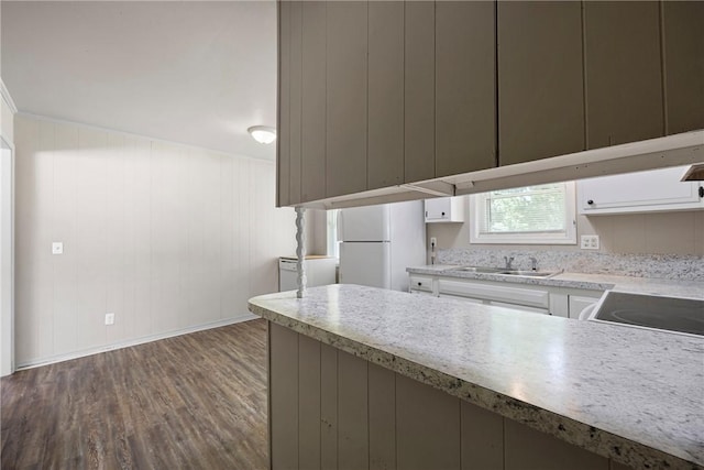 806 W 3rd St, Russellville, AR 72801 - kitchen with freestanding refrigerator, a sink, wood finished floors, light countertops, and white cabinets