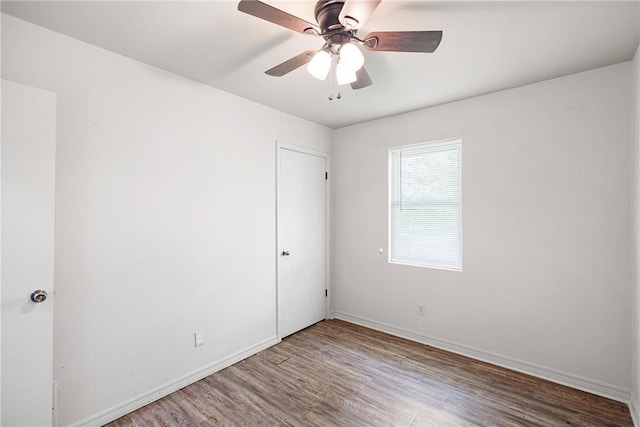 806 W 3rd St, Russellville, AR 72801 - spare room with wood finished floors, ceiling fan, and baseboards