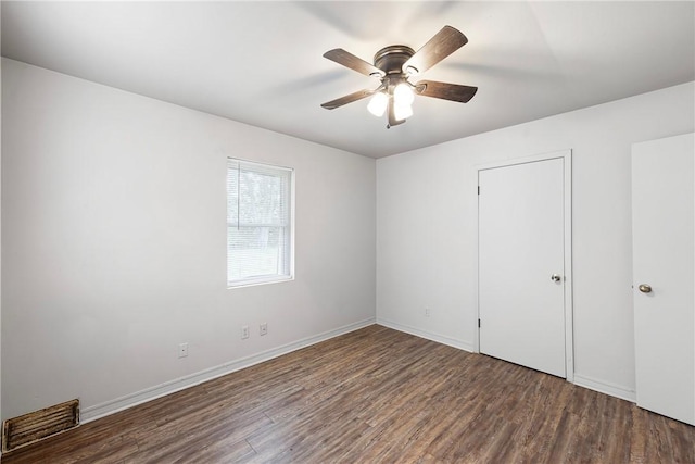 806 W 3rd St, Russellville, AR 72801 - unfurnished bedroom featuring wood finished floors, ceiling fan, and baseboards