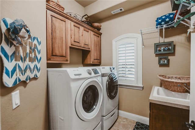 11136 W Stonebriar Dr, Bentonville, AR 72712 - laundry area featuring washing machine and dryer, cabinet space, baseboards, and light tile patterned flooring