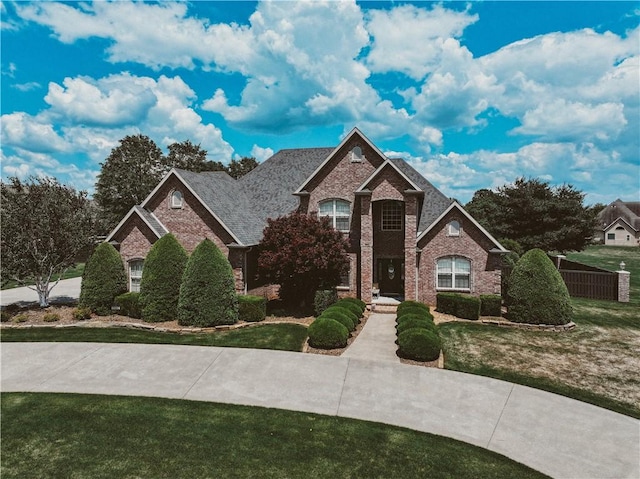 11136 W Stonebriar Dr, Bentonville, AR 72712 - traditional-style home with brick siding and a front yard