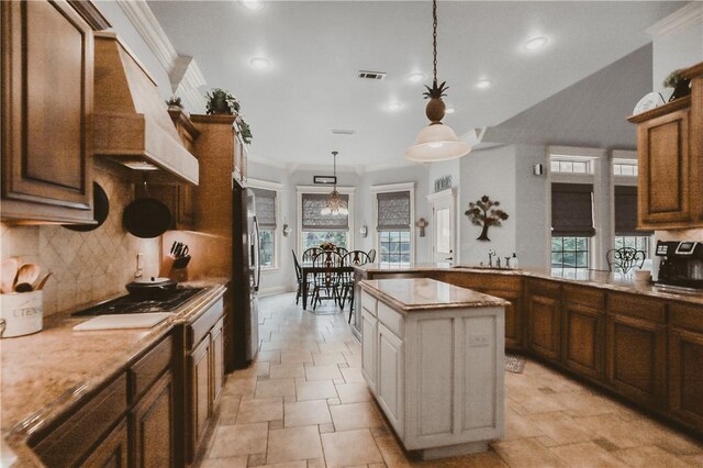 11136 W Stonebriar Dr, Bentonville, AR 72712 - kitchen with freestanding refrigerator, stone tile floors, decorative light fixtures, tasteful backsplash, and recessed lighting
