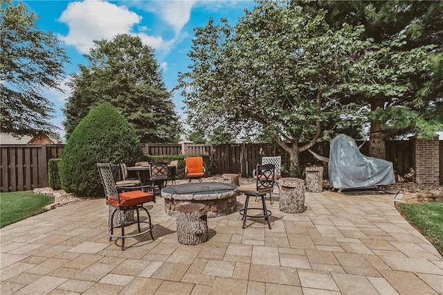 11136 W Stonebriar Dr, Bentonville, AR 72712 - fenced backyard featuring a fire pit and a patio area