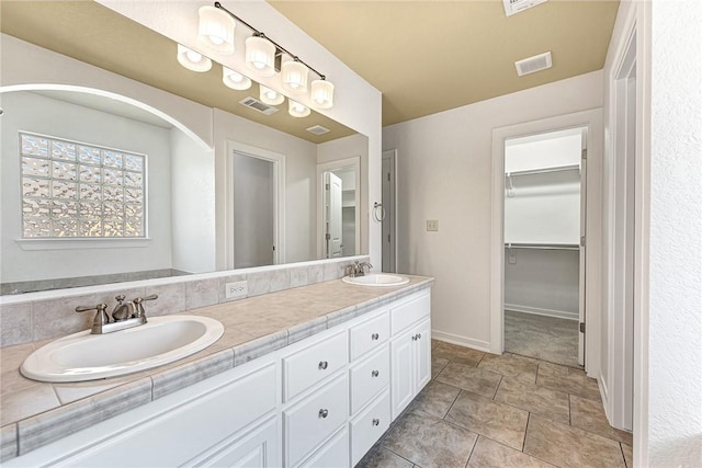 3658 W Mountain View Dr, Fayetteville, AR 72704 - bathroom featuring baseboards, double vanity, and a spacious closet