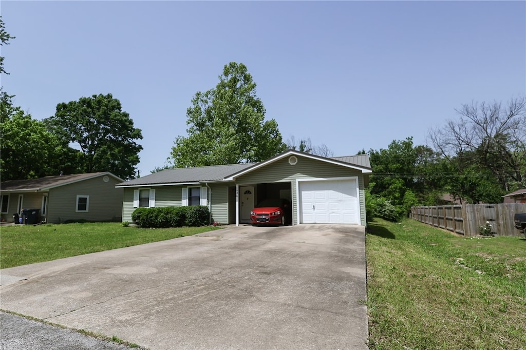 ranch-style house featuring metal roof and concrete driveway