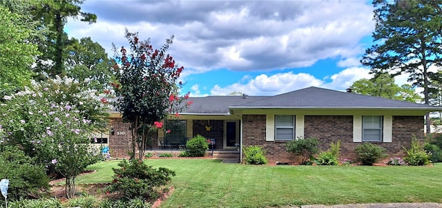 single story home featuring brick siding and a front yard