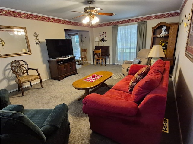 living area with a ceiling fan, carpet floors, healthy amount of natural light, and ornamental molding