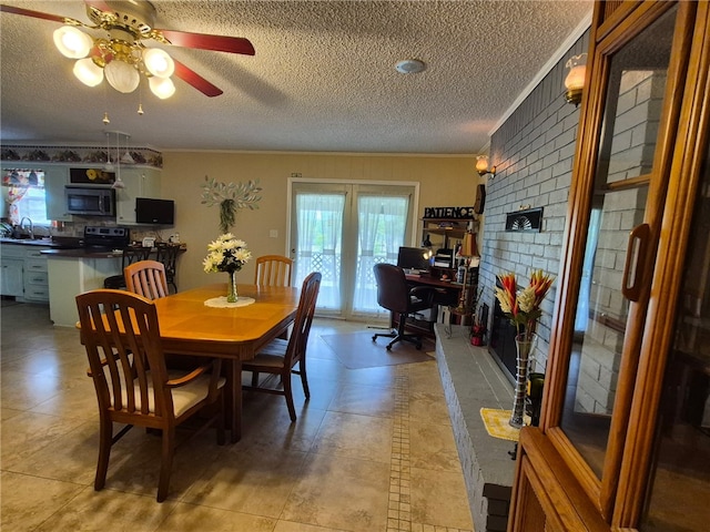 dining room featuring ornamental molding, a textured ceiling, ceiling fan, an office area, and light tile patterned floors