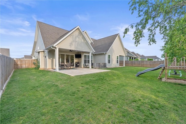 rear view of house with ceiling fan and a patio