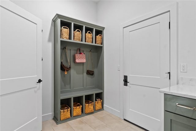 mudroom featuring light tile patterned flooring and baseboards