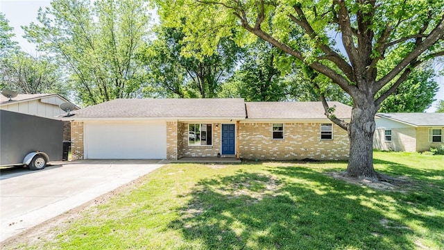 single story home with an attached garage, brick siding, driveway, and a front lawn